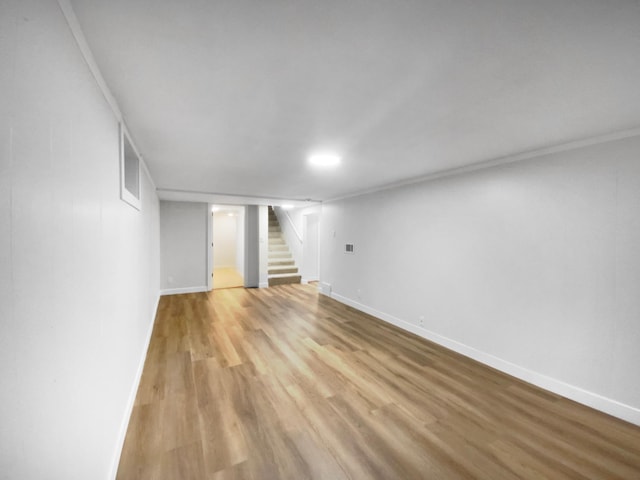 11601 Wren St NW, Coon Rapids, MN 55433 - finished basement featuring stairway, light wood-type flooring, and baseboards