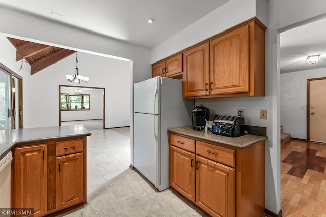 19405 Parkview Ave N, Scandia, MN 55073 - kitchen with freestanding refrigerator, brown cabinets, a chandelier, dark countertops, and wooden ceiling