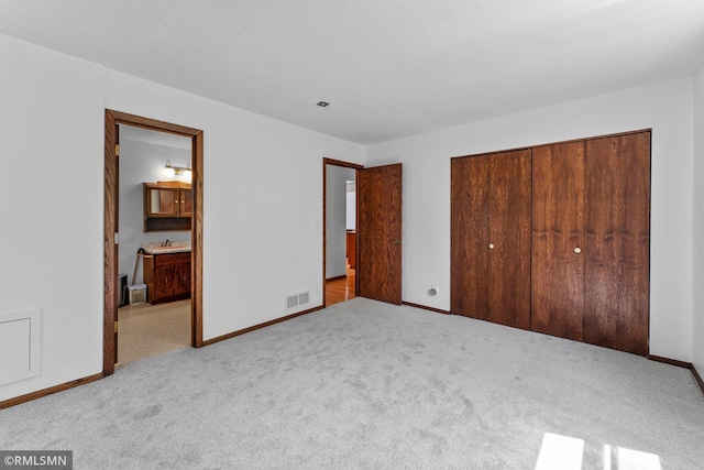 19405 Parkview Ave N, Scandia, MN 55073 - unfurnished bedroom featuring a closet, carpet, and connected bathroom