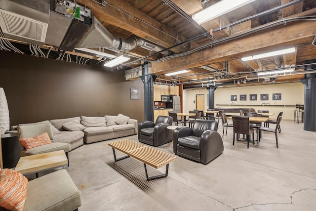 living area with concrete floors and visible vents
