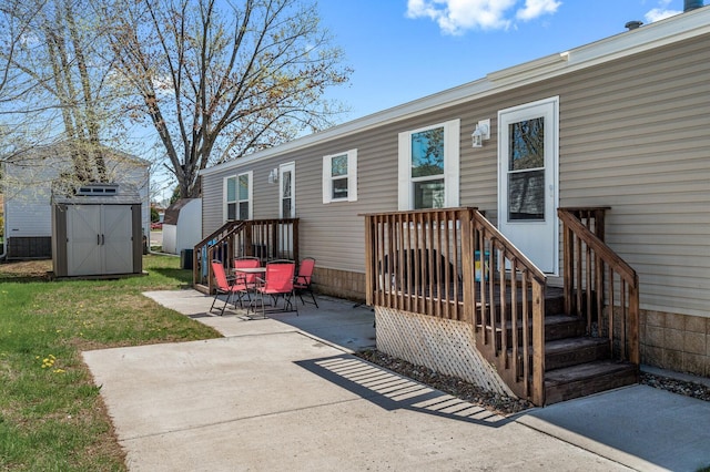 5702 Cabot Dr, Mounds View, MN 55112 - back of property with a yard, an outdoor structure, a patio area, and a storage unit