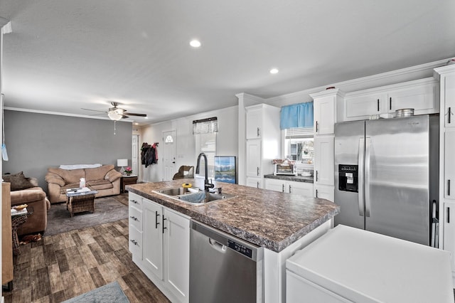 5702 Cabot Dr, Mounds View, MN 55112 - kitchen featuring dark wood-style flooring, an island with sink, ceiling fan, a sink, and appliances with stainless steel finishes