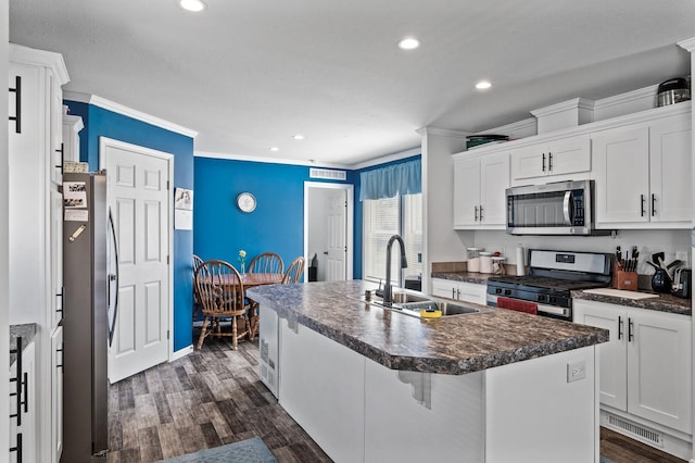 5702 Cabot Dr, Mounds View, MN 55112 - kitchen featuring a sink, appliances with stainless steel finishes, dark countertops, and ornamental molding
