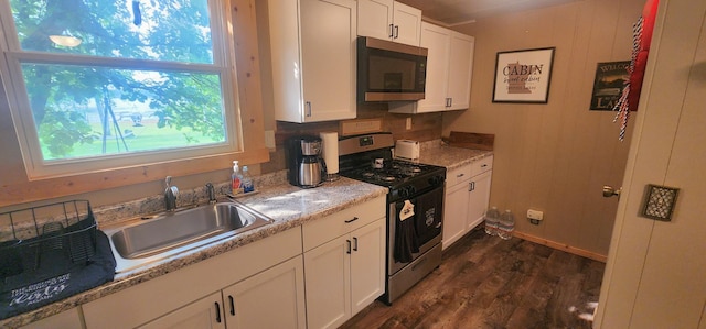 30280 County Highway 26, Holmesville Twp, MN 56501 - kitchen featuring dark wood-style flooring, stainless steel appliances, white cabinetry, and a sink