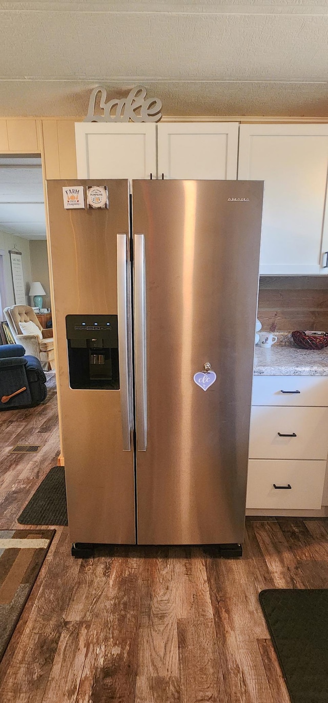30280 County Highway 26, Holmesville Twp, MN 56501 - details with white cabinets, dark wood-type flooring, and stainless steel fridge with ice dispenser