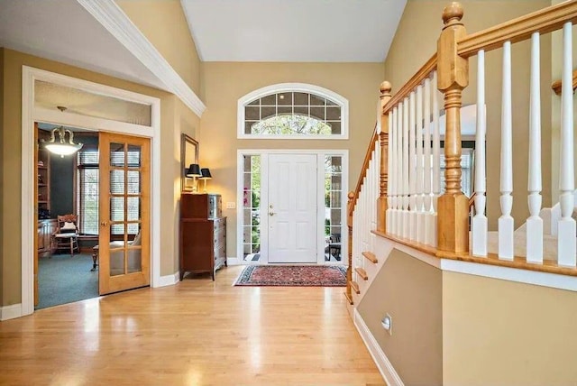 1849 Orchard Hl, Mendota Heights, MN 55118 - foyer with high vaulted ceiling, wood finished floors, baseboards, and stairs