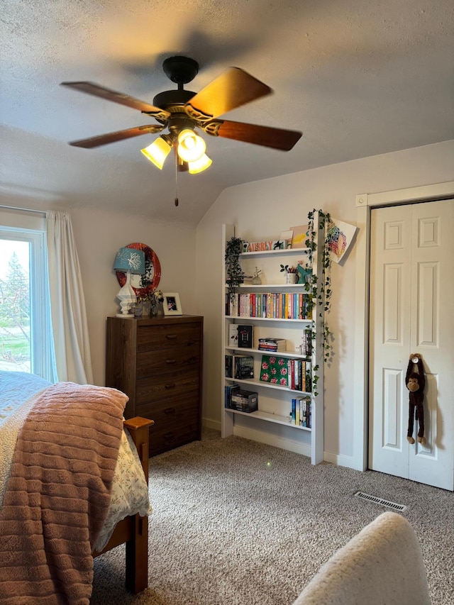 601 Maplewood Dr SE, Pelican Rapids, MN 56572 - carpeted bedroom with a ceiling fan, a textured ceiling, lofted ceiling, and baseboards