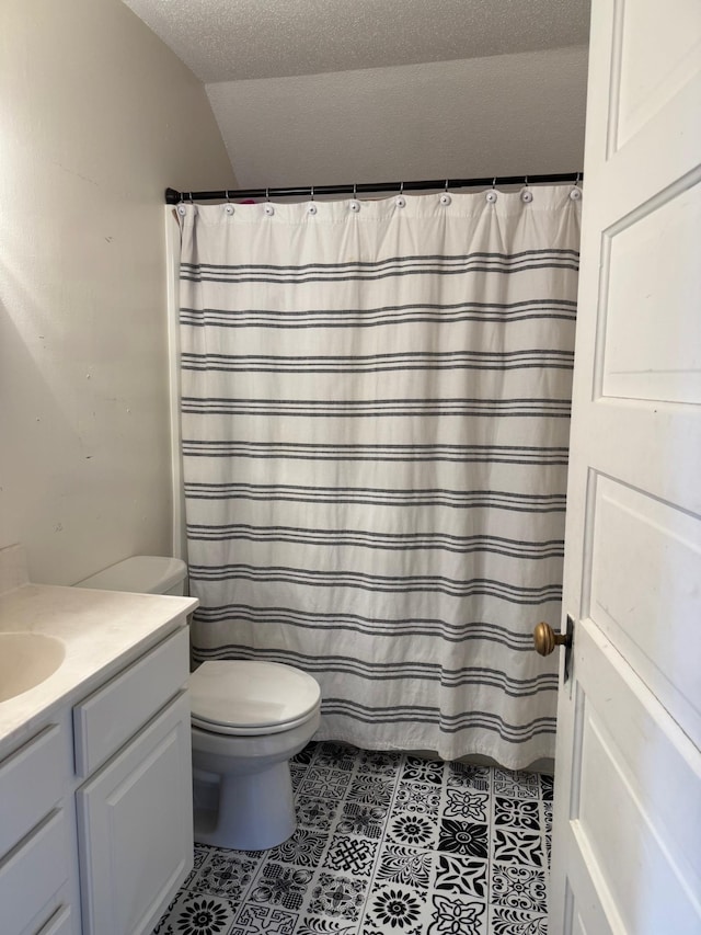 601 Maplewood Dr SE, Pelican Rapids, MN 56572 - bathroom featuring vanity, tile patterned floors, toilet, vaulted ceiling, and a textured ceiling