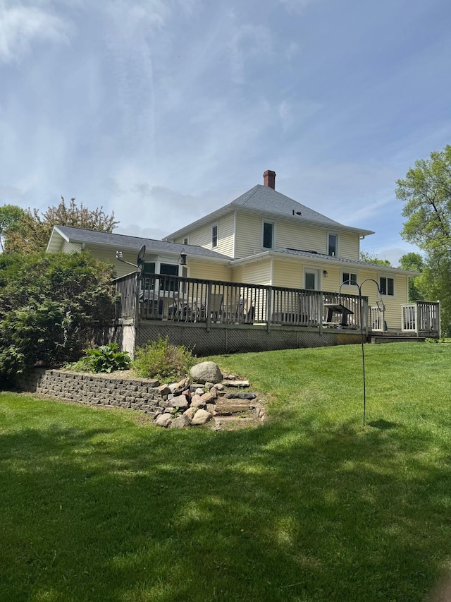 601 Maplewood Dr SE, Pelican Rapids, MN 56572 - back of house featuring a deck, a chimney, and a lawn