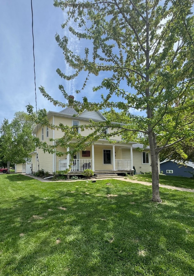 601 Maplewood Dr SE, Pelican Rapids, MN 56572 - view of front of property featuring a porch, a front lawn, and a chimney