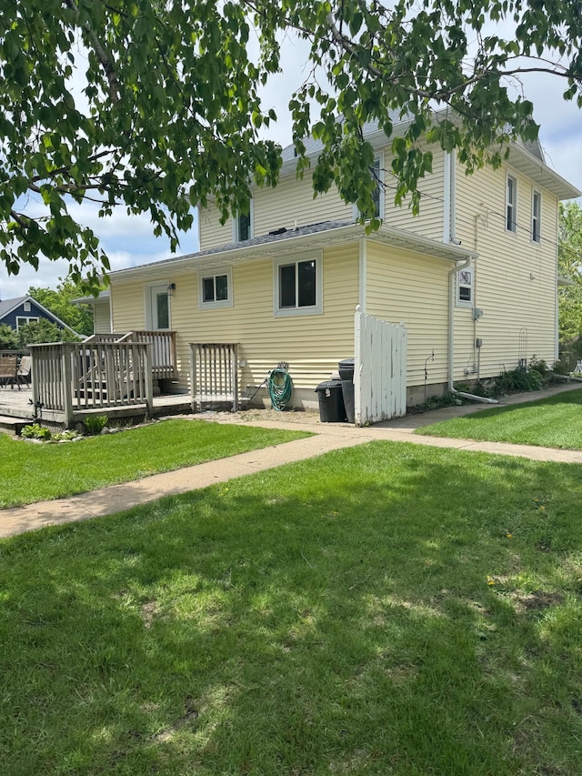 601 Maplewood Dr SE, Pelican Rapids, MN 56572 - back of house with a wooden deck and a yard