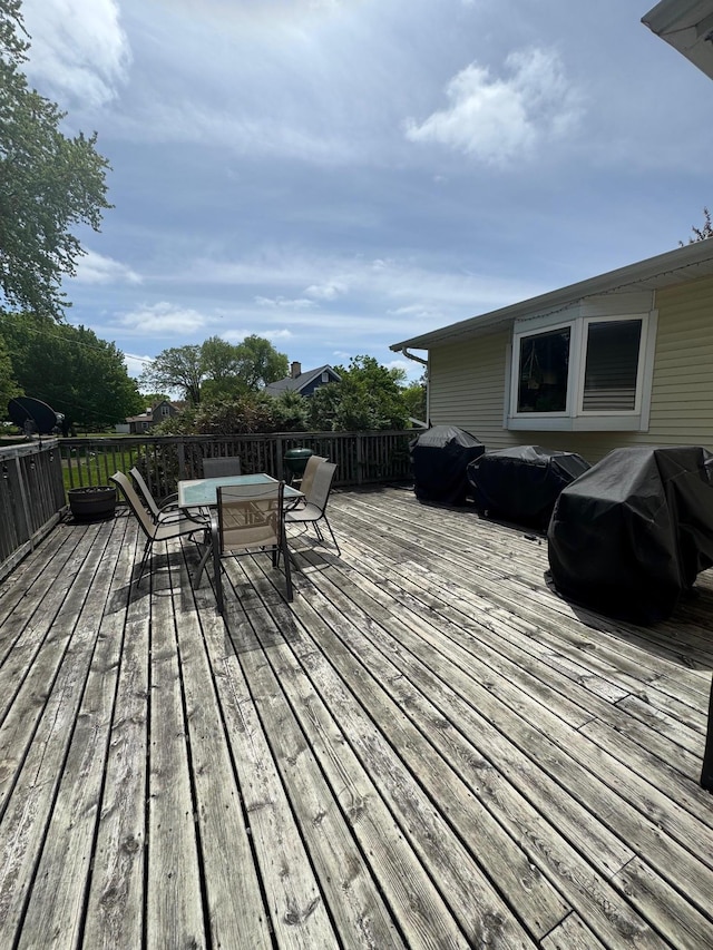 601 Maplewood Dr SE, Pelican Rapids, MN 56572 - wooden terrace featuring outdoor dining area and grilling area