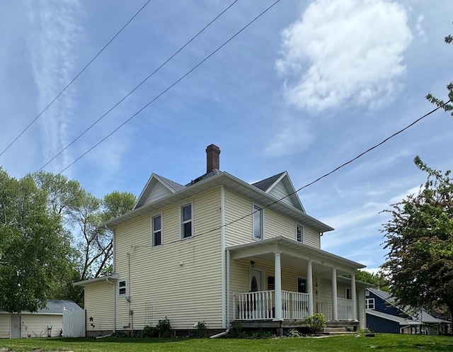 601 Maplewood Dr SE, Pelican Rapids, MN 56572 - back of property with covered porch, a chimney, and a yard
