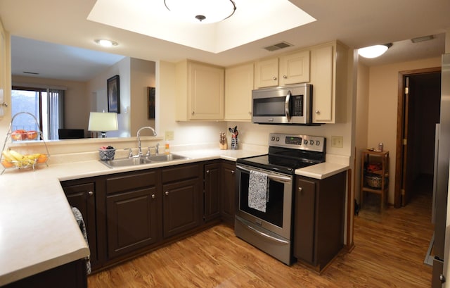 kitchen with light countertops, visible vents, appliances with stainless steel finishes, and a sink
