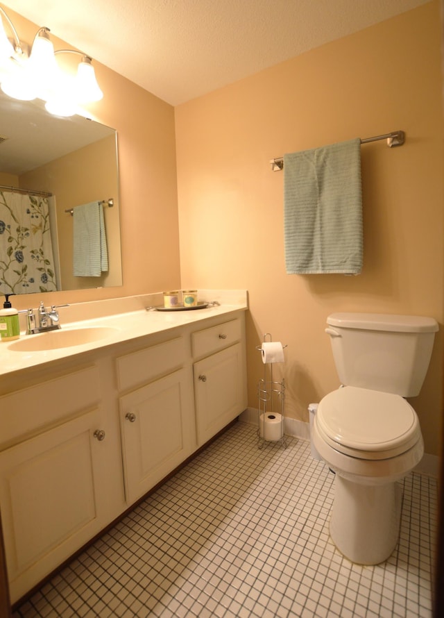 full bath featuring tile patterned flooring, baseboards, toilet, and vanity