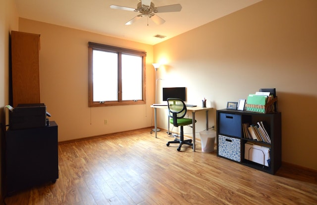 home office with baseboards, wood finished floors, visible vents, and ceiling fan