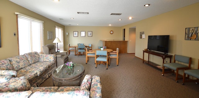 carpeted living area featuring visible vents and recessed lighting