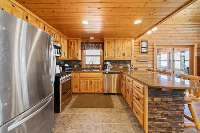 2746 Swift Ln NW, Hackensack, MN 56452 - kitchen with stainless steel appliances, a sink, rustic walls, wooden ceiling, and a peninsula