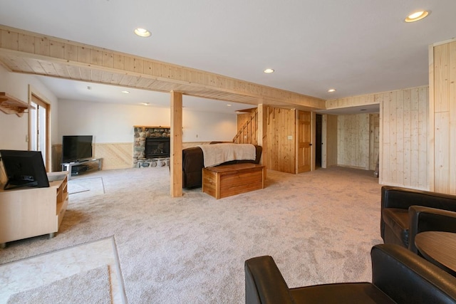 2746 Swift Ln NW, Hackensack, MN 56452 - carpeted living room featuring wood walls, stairs, recessed lighting, and a fireplace