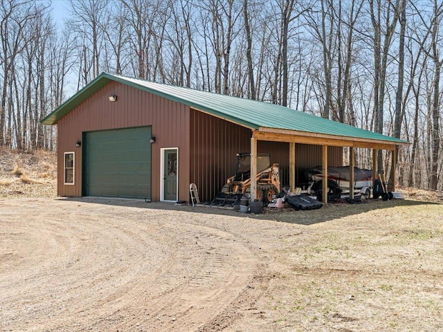 garage with a garage and dirt driveway