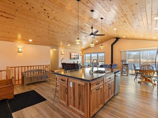 kitchen with dark countertops, vaulted ceiling, dishwasher, a sink, and wooden ceiling