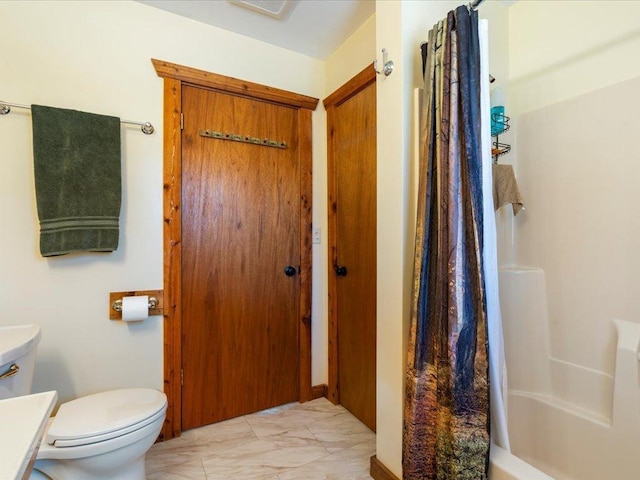 bathroom featuring visible vents, marble finish floor, shower / bath combination with curtain, and toilet