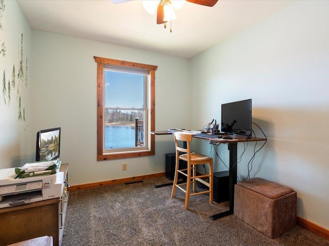 carpeted home office featuring baseboards and ceiling fan