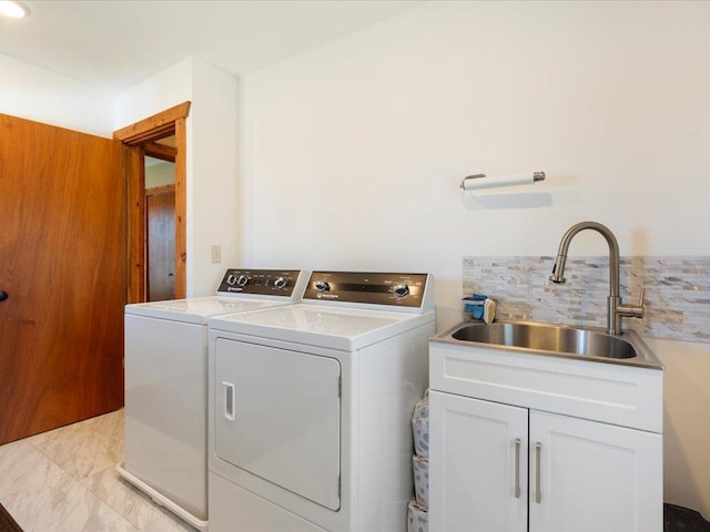 laundry area featuring a sink, cabinet space, and independent washer and dryer