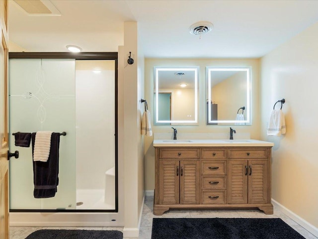 bathroom featuring visible vents, a sink, baseboards, and a shower stall