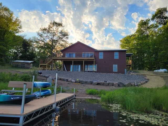 rear view of property featuring stairway and a deck