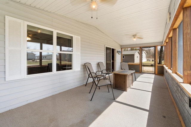 sunroom / solarium with a ceiling fan