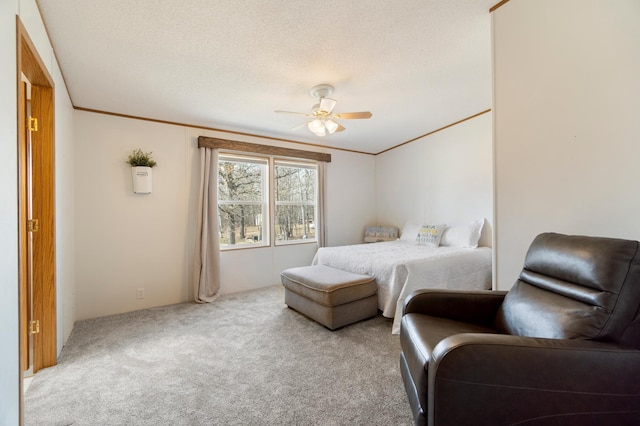 carpeted bedroom with a ceiling fan, a textured ceiling, and crown molding