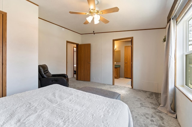bedroom with a ceiling fan, crown molding, connected bathroom, and carpet
