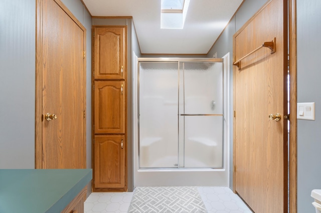 bathroom with tile patterned floors and a shower stall