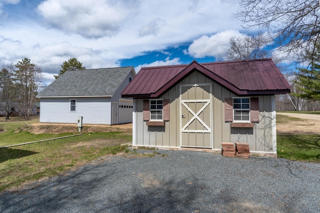 view of outdoor structure with a garage and an outbuilding