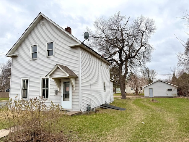 view of front of house featuring a chimney and a front yard