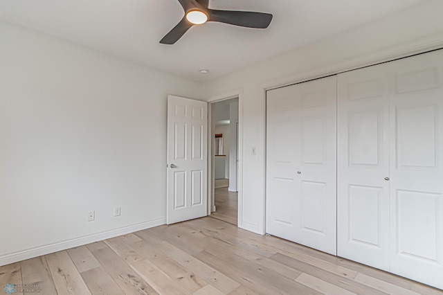 3463 Loberg Dr, West Fargo, ND 58078 - unfurnished bedroom featuring light wood-style floors, a closet, baseboards, and ceiling fan