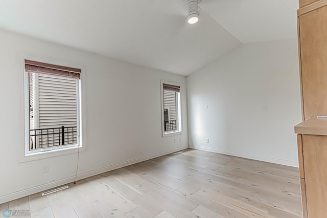 3463 Loberg Dr, West Fargo, ND 58078 - unfurnished room featuring vaulted ceiling, a ceiling fan, light wood finished floors, and baseboards