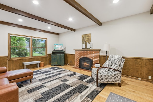 15325 Holdridge Dr E, Minnetonka, MN 55391 - living room featuring wainscoting, wood finished floors, wood walls, recessed lighting, and a brick fireplace