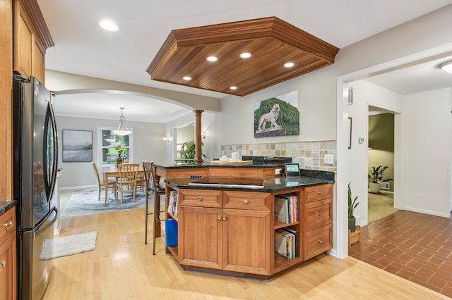 15325 Holdridge Dr E, Minnetonka, MN 55391 - kitchen with black appliances, arched walkways, ornate columns, decorative backsplash, and brown cabinets