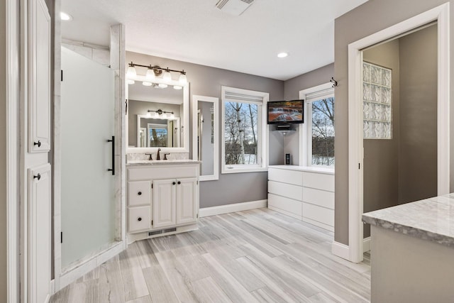 5320 132nd St W, Apple Valley, MN 55124 - bathroom featuring recessed lighting, wood finished floors, vanity, baseboards, and visible vents