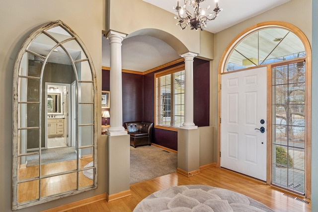 5320 132nd St W, Apple Valley, MN 55124 - foyer featuring arched walkways, ornate columns, wood finished floors, baseboards, and visible vents