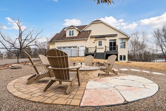 5320 132nd St W, Apple Valley, MN 55124 - rear view of property featuring a deck, an outdoor fire pit, fence, a patio area, and roof with shingles