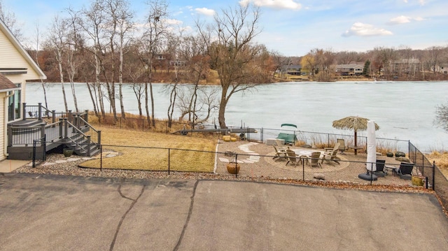 5320 132nd St W, Apple Valley, MN 55124 - view of yard featuring fence, an outdoor fire pit, a water view, and a patio