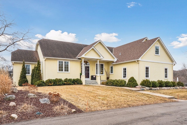 5320 132nd St W, Apple Valley, MN 55124 - view of front of home with a front yard, stucco siding, and roof with shingles