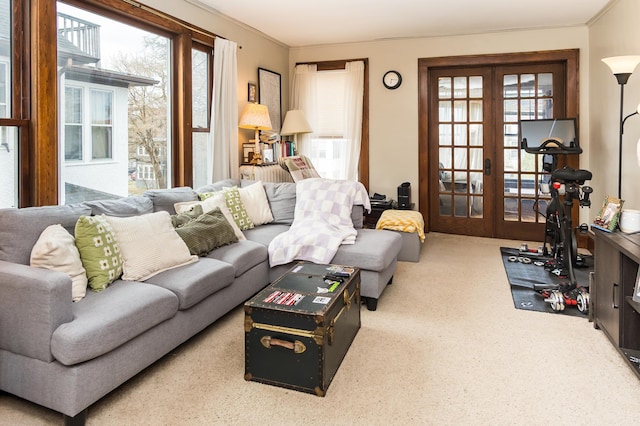 living room featuring carpet floors, ornamental molding, and french doors
