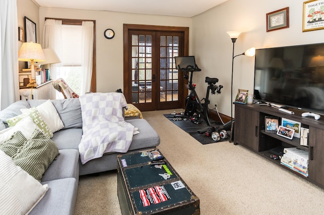 carpeted living area with french doors