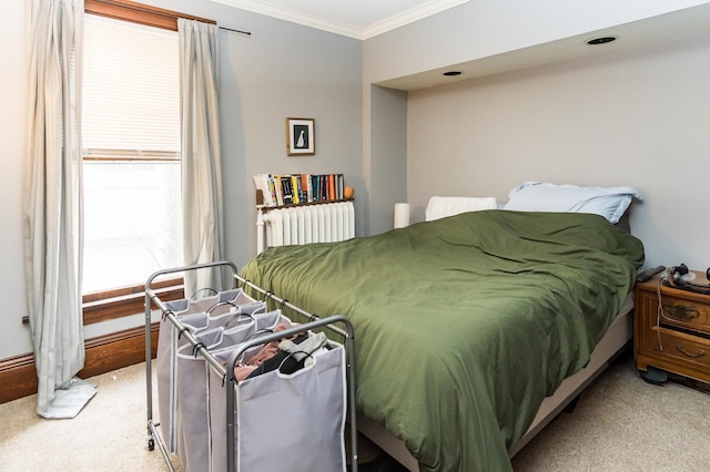 bedroom with crown molding and light colored carpet