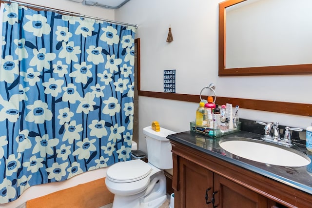 full bathroom with toilet and vanity