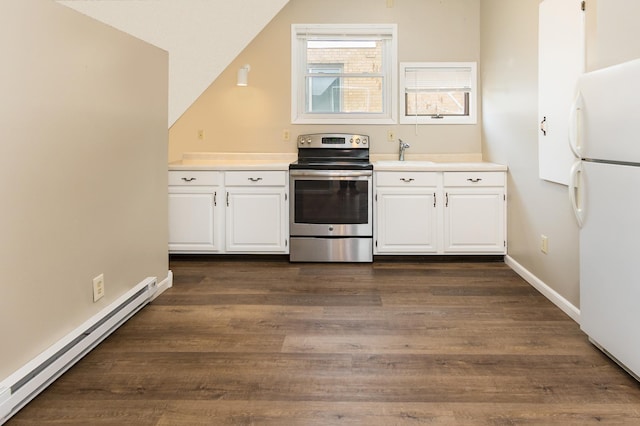 kitchen featuring baseboard heating, white cabinets, stainless steel range with electric cooktop, and freestanding refrigerator
